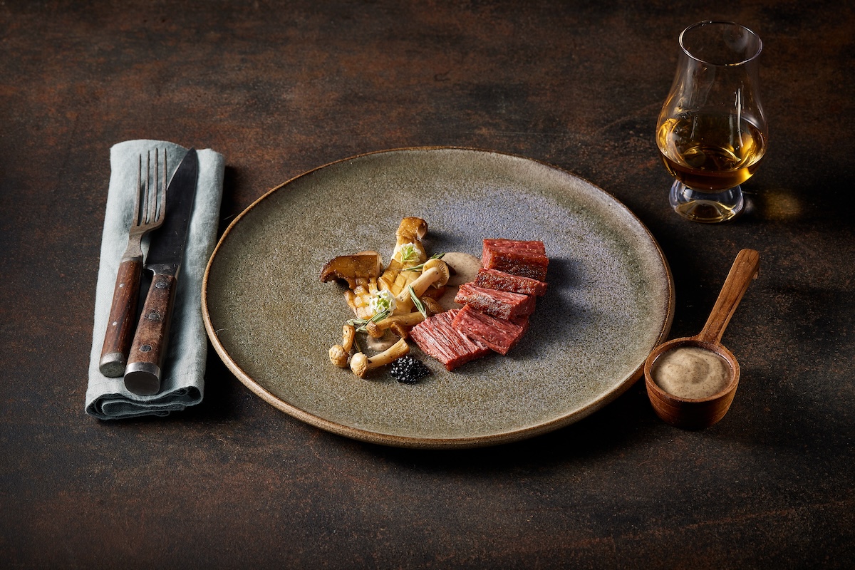 Redefine Beef Flank served with mushrooms at a restaurant - the cuts will roll out to more European restaurants this year - new plant-based foods for 2024